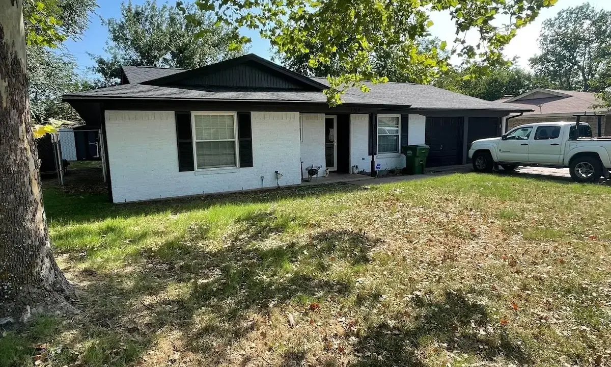 Professional roofing crew working on a residential roof in Giddings